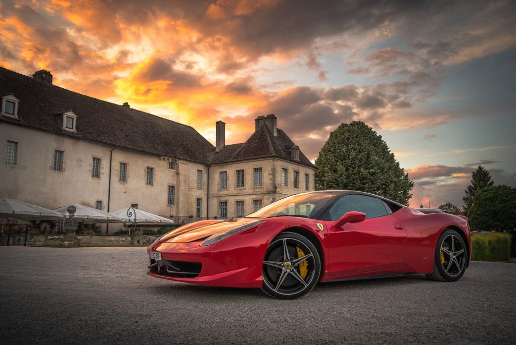 A luxury car in front of European villa